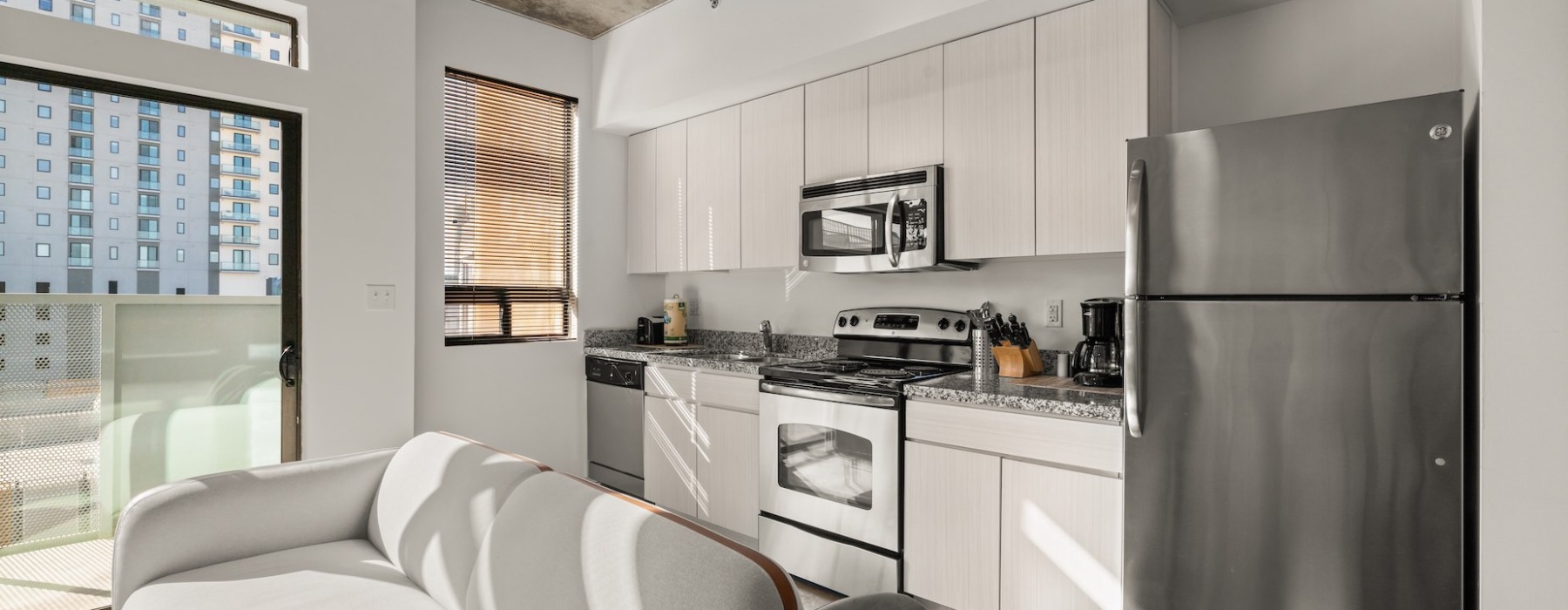 studio apartment with large glass windows and lots of natural light