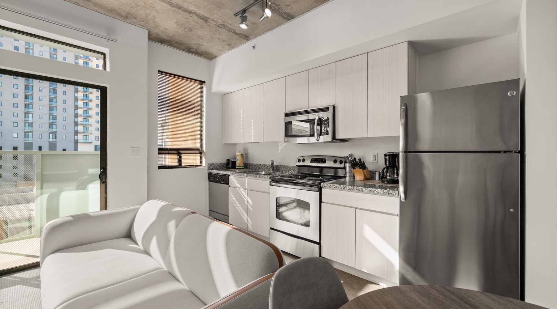 studio apartment with large glass windows and lots of natural light