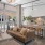 A sofa, coffee table, and kitchen with bar seating in a community space overlooking a swimming pool at Adara apartments in Downtown Phoenix AZ.