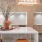 A clay vase with a floral arrangement and books on a quartz kitchen island in Adara apartments' Downtown Phoenix, AZ community space.