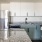 Fully Equipped Renovated Kitchen with Stainless Steel Appliances and White Cabinetry 