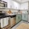 A spacious kitchen with stainless steel appliances, quartz countertops, and amble cabinet space at Adara apartments in Downtown Phoenix, AZ.