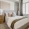large windows brighten carpeted bedroom