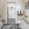 shower/tub combo in bright bathroom with walk-in closet